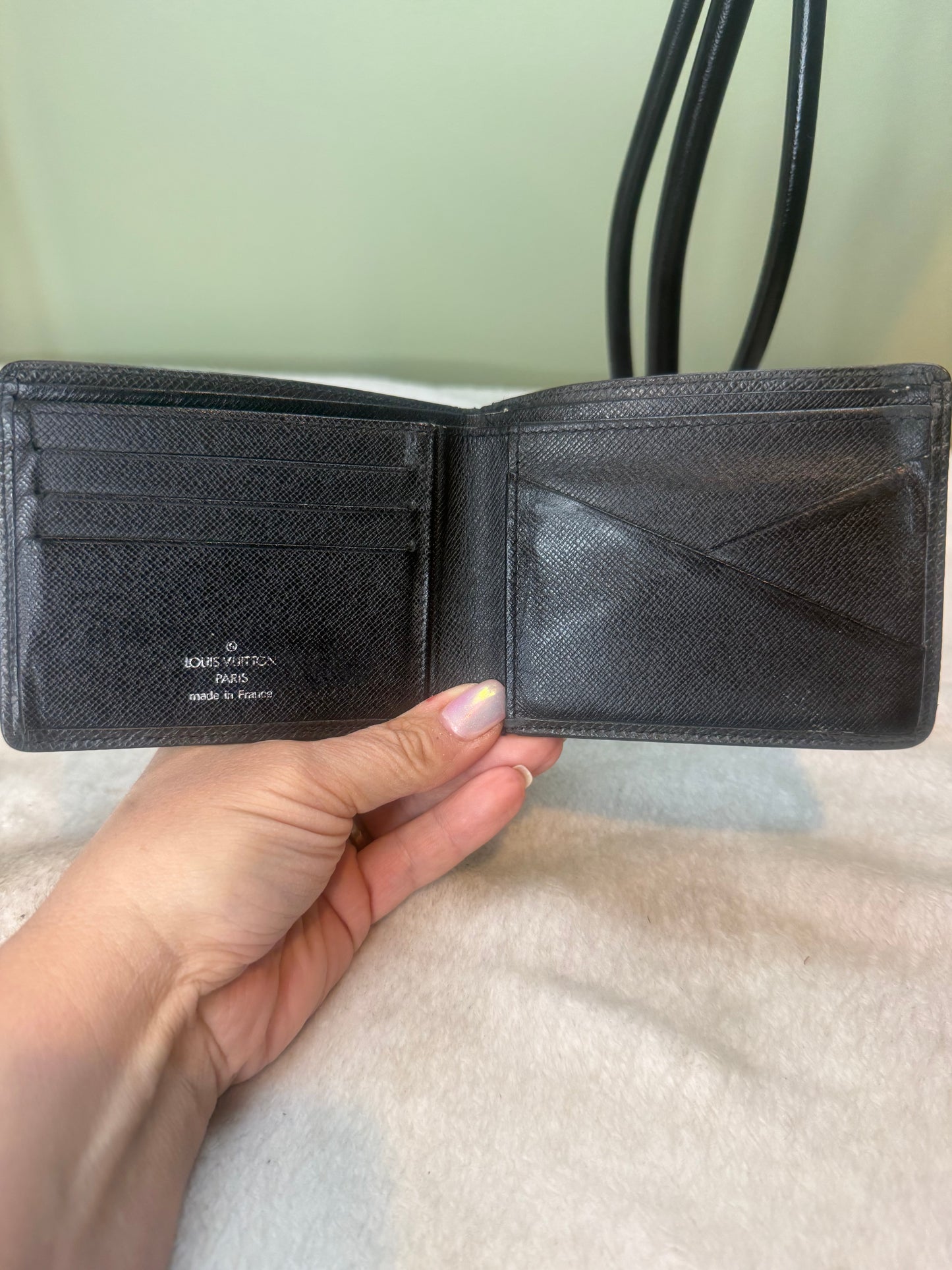 1169. Louis Vuitton Black Tiaga Leather Mens bifold