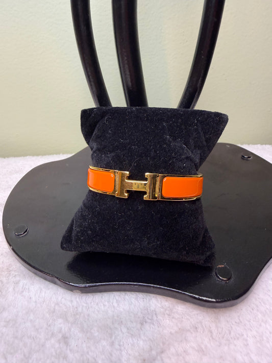 1579. Hermes Clic Clac H Orange and Gold Bracelet