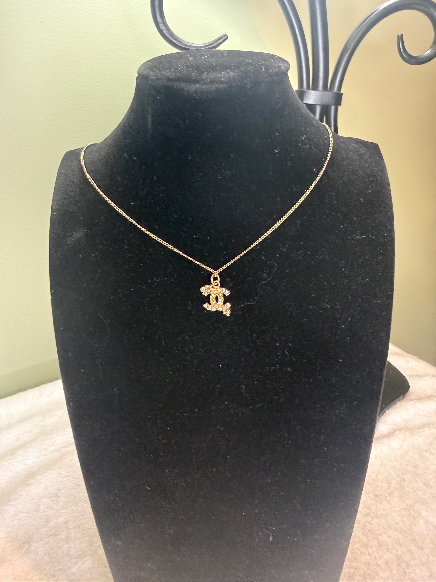 1306. Chanel Gold Toned small Crystal Encrusted Interlocking CC necklace