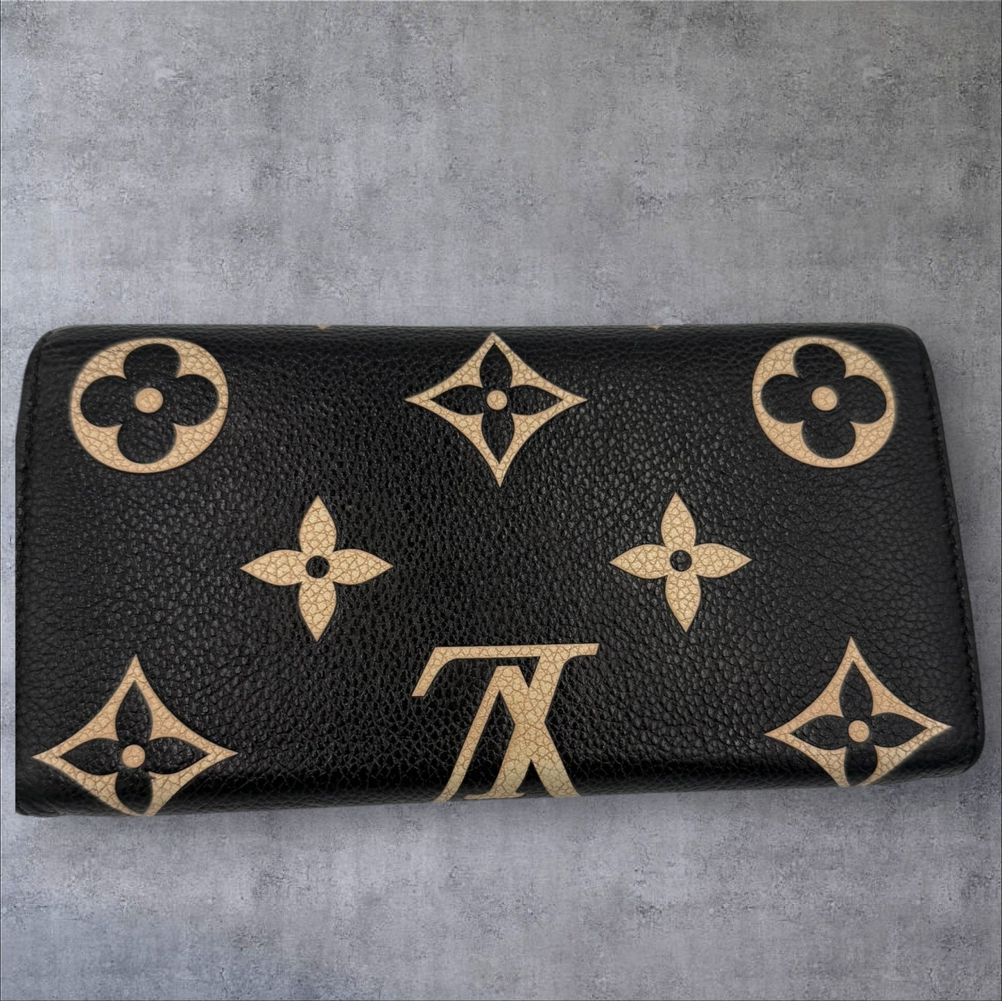 400. Louis Vuitton Bicolor Monogram Empriente Sarah Wallet