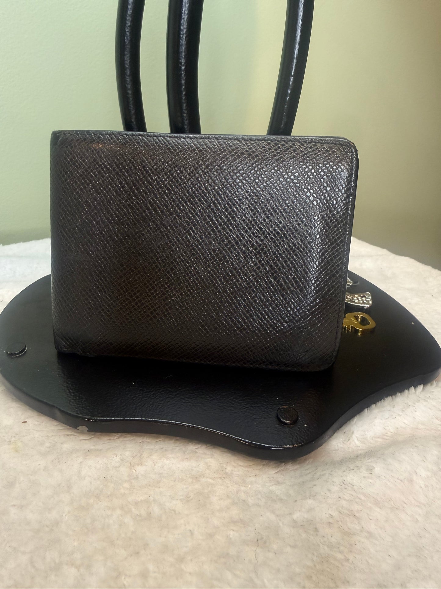 1169. Louis Vuitton Black Tiaga Leather Mens bifold