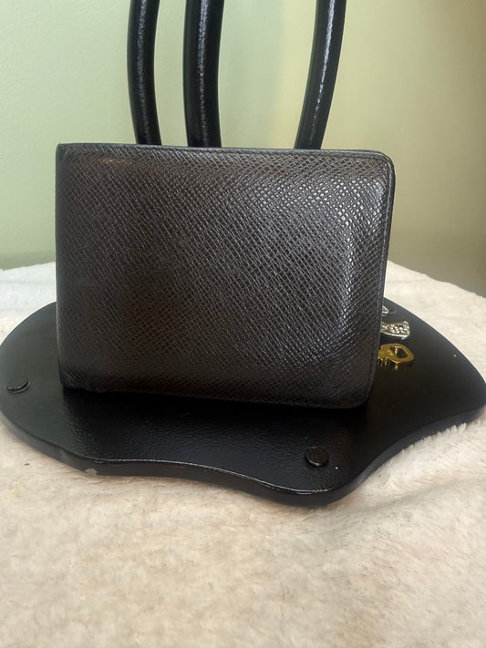 1169. Louis Vuitton Black Tiaga Leather Mens bifold